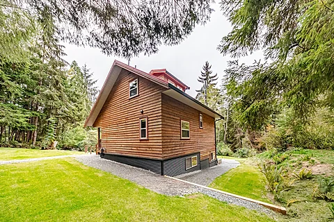 Cabin exterior with a forest deck at dusk, Kelowna real estate photography