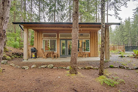Covered deck with seating overlooking the forest, Sooke real estate photography