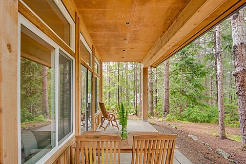 Cabin living room with floor-to-ceiling windows onto the forest, Sooke real estate photography