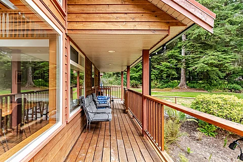 Cabin living room with a fireplace and large windows, Sooke real estate photography