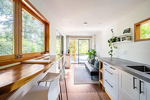 Cabin kitchen with white cabinets and an island, Sooke real estate photography