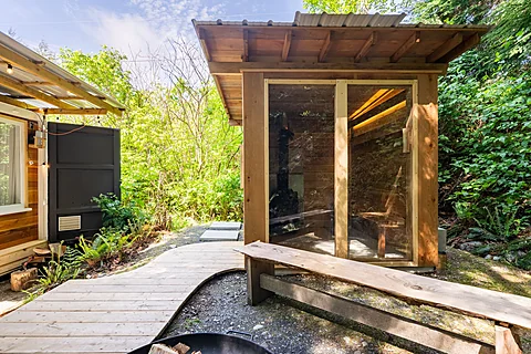Covered cedar deck with an outdoor dining area, Sooke real estate photography