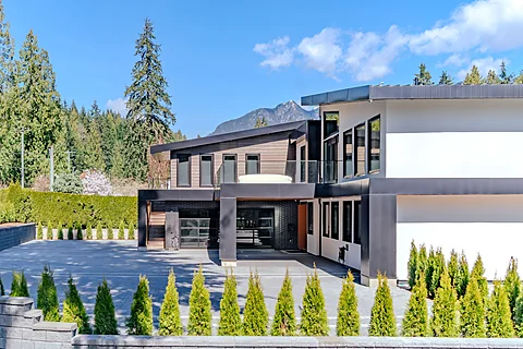 Modern multi-level home exterior set among the trees, North Vancouver real estate photography