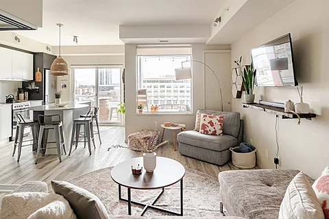 Condo living area with a sofa and bright windows, Kelowna real estate photography