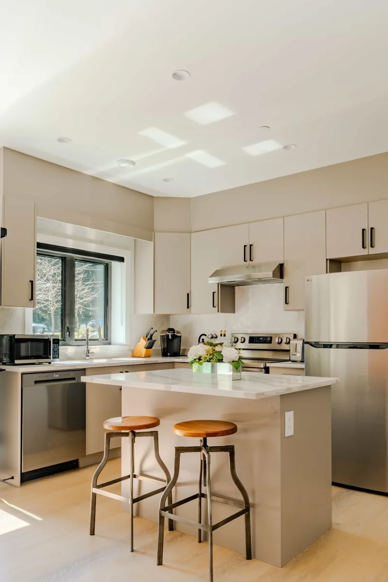 Airbnb kitchen with island and bar stools