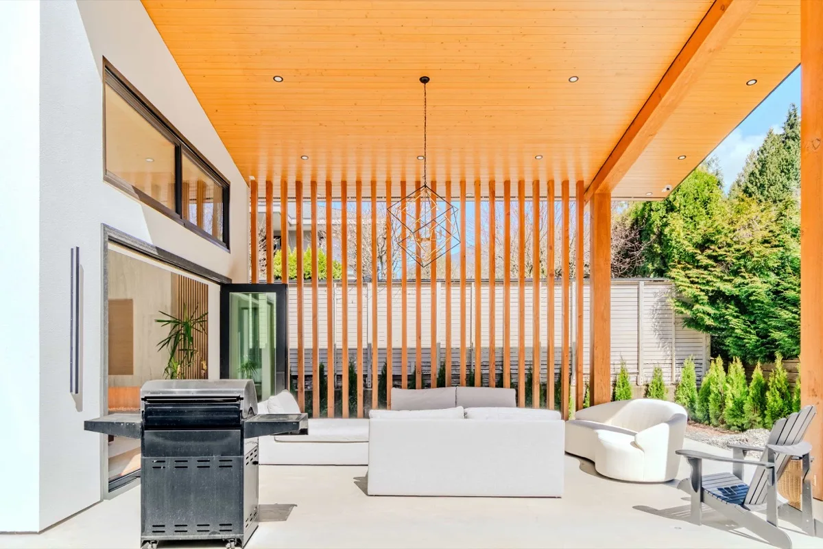 Covered outdoor living area with BBQ and seating